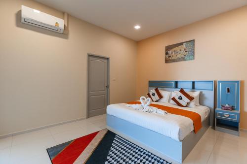a bedroom with two beds and a air conditioner at Villa Aura Chiang Mai in Chiang Mai