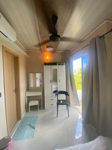 a living room with a chair and a desk at Portia Beach Grand in Hulhumale