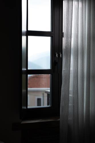 an open window with a view of a building at Maison Michelangelo in Arachova