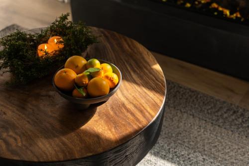 a bowl of fruit on a wooden table at Maison Michelangelo in Arachova