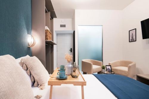 a bedroom with a bed and a table and chairs at Easylife - FL Suite in Centrale in Milan