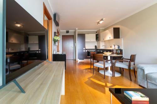 a living room and kitchen with a couch and a table at The Residence Aparthotel in Podstrana