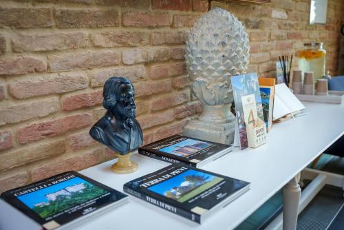 a table with a statue and pictures on it at Best Western Hotel Green City in Parma