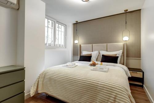une chambre avec un grand lit avec deux serviettes dessus dans l'établissement 362 Suite Lafayette - Superbe Appartement à Paris, à Paris