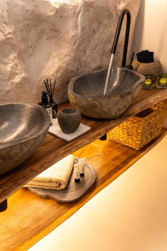 a bathroom with two sinks on a wooden shelf at Maison Michelangelo in Arachova