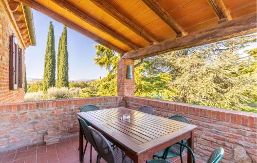a patio with a wooden table and chairs at Nice Apartment In Castiglione Del Lago in Castiglione del Lago