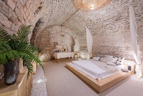 a bedroom with a bed in a brick wall at Aura Spa in Vilnius