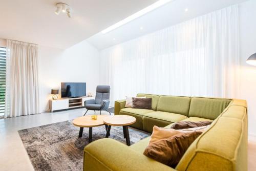 a living room with a couch and a table at De Plevieren in Buren