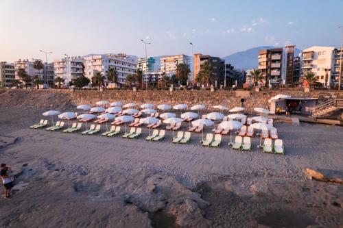 a group of chairs with umbrellas on a beach at Scylax Hotels Mahmutlar in Alanya