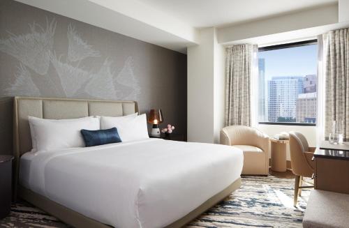 a bedroom with a large bed and a large window at InterContinental Seattle Bellevue, by IHG in Bellevue