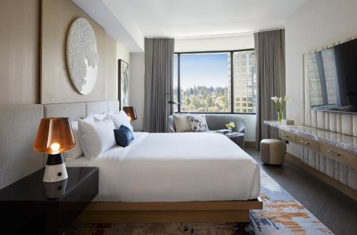 a bedroom with a large white bed and a large window at InterContinental Seattle Bellevue, by IHG in Bellevue