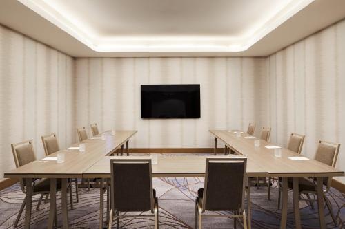 a conference room with tables and chairs and a tv at InterContinental Seattle Bellevue, by IHG in Bellevue