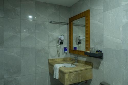 a bathroom with a sink and a mirror at Scylax Hotels Mahmutlar in Alanya
