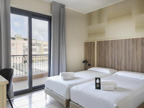 Postel nebo postele na pokoji v ubytování B&B HOTEL Pomezia Cortese