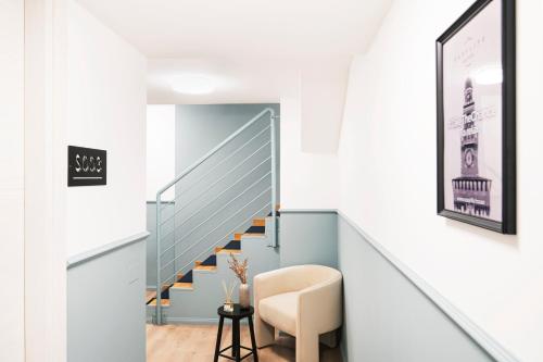 a staircase in a house with a chair and a stair case at Easylife - FL Suite in Centrale in Milan