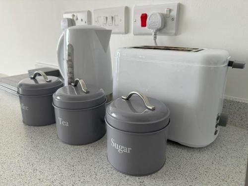 a kitchen counter with four pots and a toilet at Harbour View - 1 Bedroom - Sleeps 2 in Whitehaven