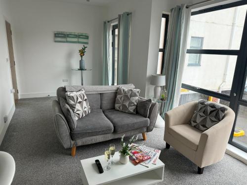 a living room with a couch and a chair at Harbour View - 1 Bedroom - Sleeps 2 in Whitehaven