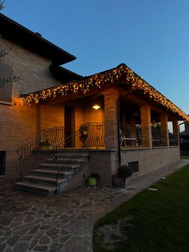 a building with stairs and lights on it at Appartamento con giardino in Pontecchio