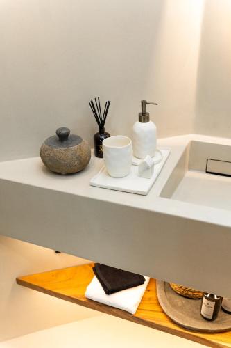a bathroom counter with a sink and some items on it at Maison Michelangelo in Arachova