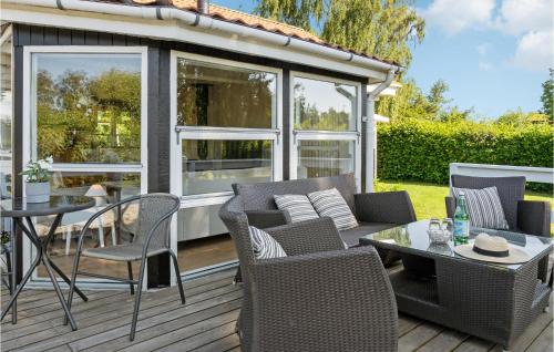 a screened in porch with a table and chairs at 2 Bedroom Amazing Home In Sydals in Neder Lysabild