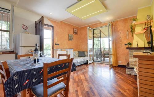 a kitchen and a dining room with a table and chairs at Awesome Apartment In Casarza Ligure in Casarza Ligure