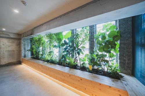 a room with a large aquarium with plants in it at nine stories hotel in Kotohira