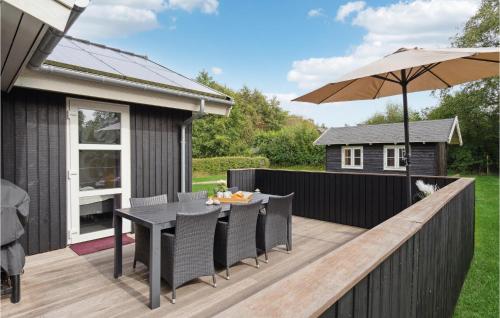 a deck with a table and an umbrella at Cozy Home In Humble With Sauna in Humble