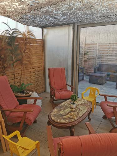 - un salon avec des chaises, une table et des chaises dans l'établissement Carnon-Plage, Beach House, à Mauguio