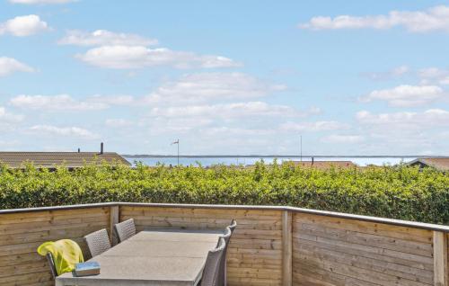 a table and chairs on a balcony with a view of the ocean at Stunning Home In Vinderup With Kitchen in Vinderup