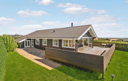 a house with a large deck in the yard at Stunning Home In Vinderup With Kitchen in Vinderup