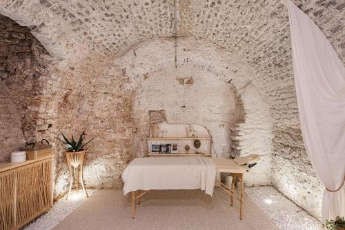 a room with a sewing machine in a stone wall at Aura Spa in Vilnius