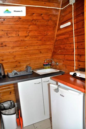 a kitchen with wooden walls and a counter at SuliCamp Kompleks Wypoczynkowy in Sulistrowice