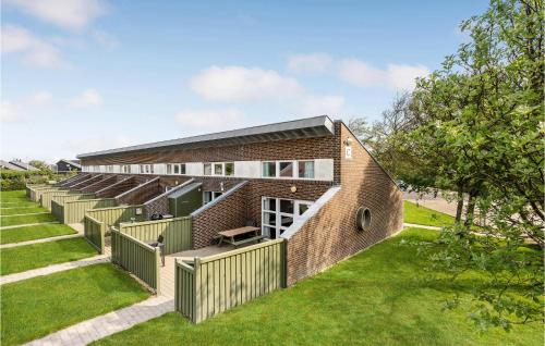 an external view of a brick building with grass at Nice Apartment In Hemmet With Sauna in Hemmet