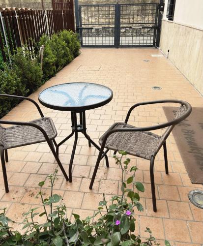 a table and two chairs sitting next to a patio at G&A Conte B&B in Angri