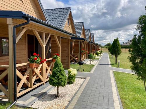 a row of cottages with flowers inront of them at USTECKA OSADA II Ustka Przewłoka in Ustka