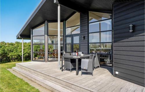 a house with a table and chairs on a deck at Beautiful Home In Hjørring With Wifi in Hjørring