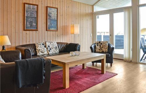 a living room with a table and a couch at Frk Lyng in Harboør