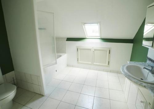 a bathroom with a toilet and a sink at Chambre Du Coq à la Ferme de Franqueville in Sainte-Marie-du-Mont