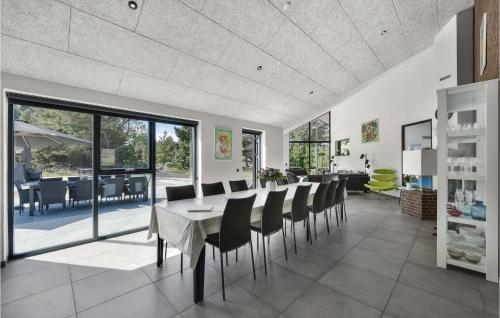 a dining room with a table and chairs at Nice Home In Blåvand With Kitchen in Blåvand