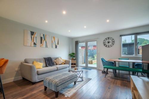 a living room with a couch and a table at 16 Waterloo Close, Newmarket in Newmarket