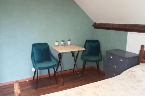 a table and two chairs in a room with a bed at Espace Spirituel in Saint-Sulpice-le-Dunois