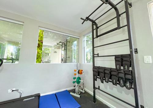 a room with a gym with a bench and a window at Pousada Nacional Inn Campos do Jordão in Campos do Jordão