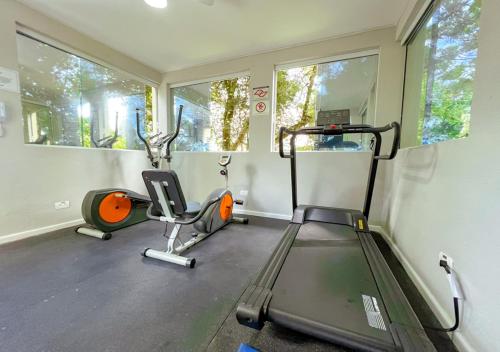 a gym with two exercise bikes and a treadmill at Pousada Nacional Inn Campos do Jordão in Campos do Jordão