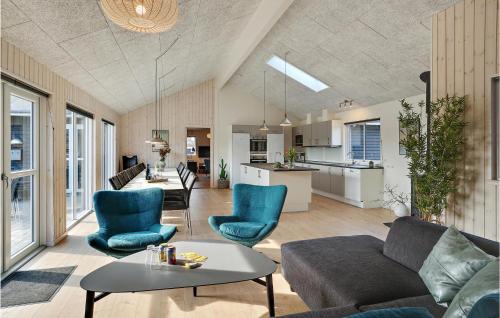 a living room with a couch and chairs and a table at Nice Home In Ålbæk With Kitchen in Ålbæk