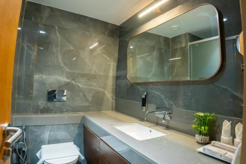 a bathroom with a sink and a mirror at Pride Elite, Daman in Daman
