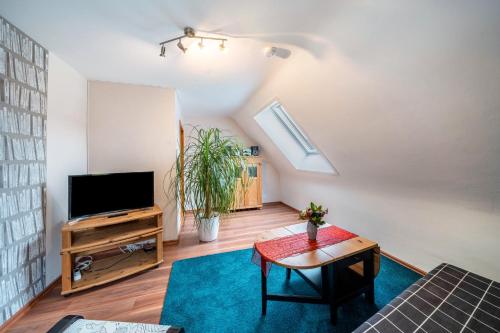 a living room with a tv and a table at Ferienwohnung Burgblick in Hausach