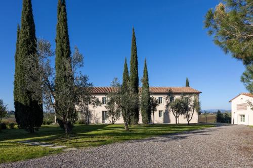 an estate with trees in front of a building at Colle Alberti Country House in Cerreto Guidi