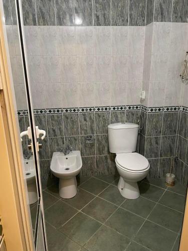 a bathroom with a toilet and a sink at Лунара in Sandanski