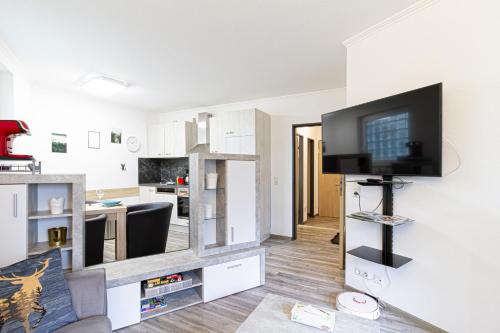 a living room with a flat screen tv on a wall at Ferienwohnung Activities & Relax, Skilift&Downhill in Winterberg