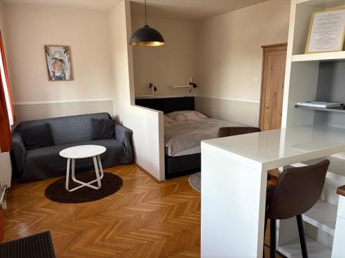 a small living room with a couch and a table at RT Home Vendégház in Szombathely